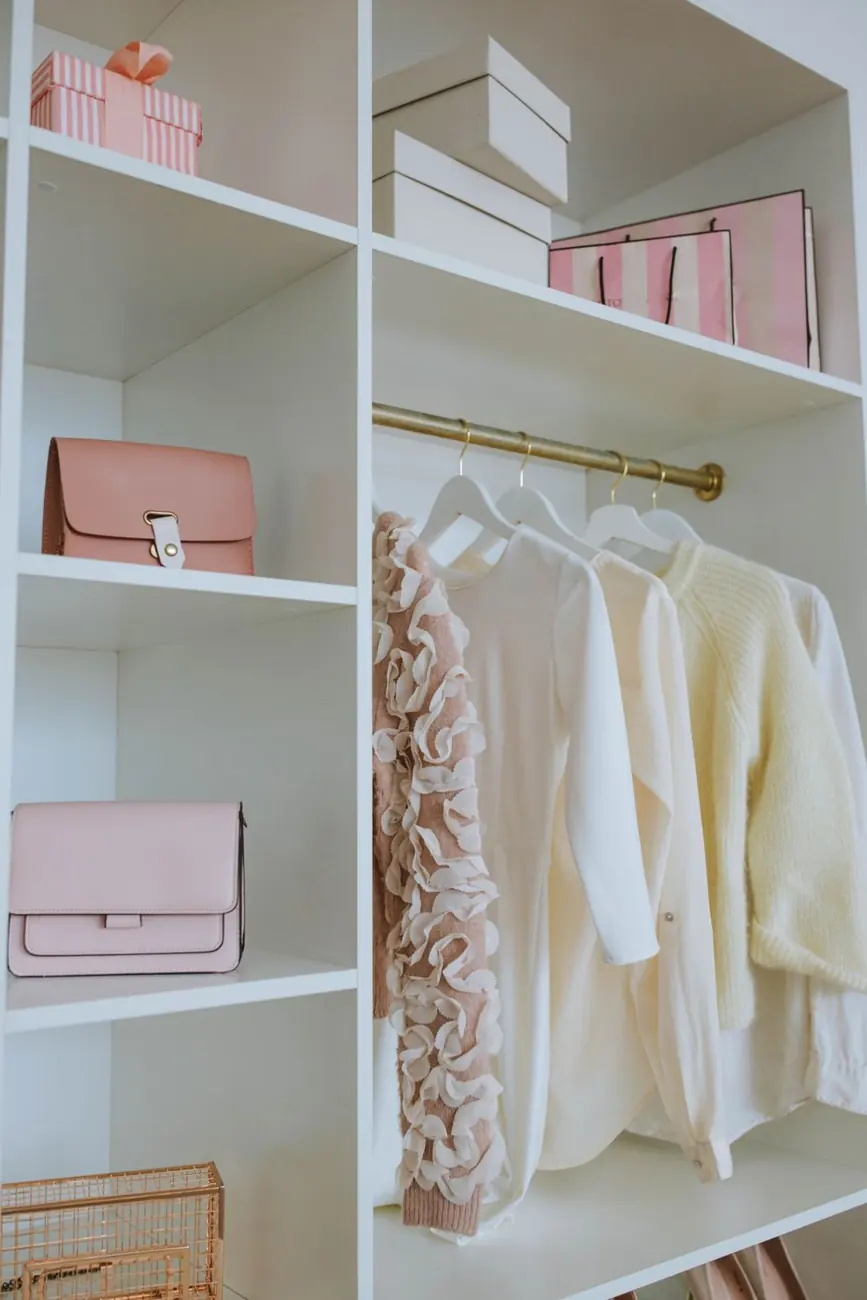 White closet with neatly arranged clothes